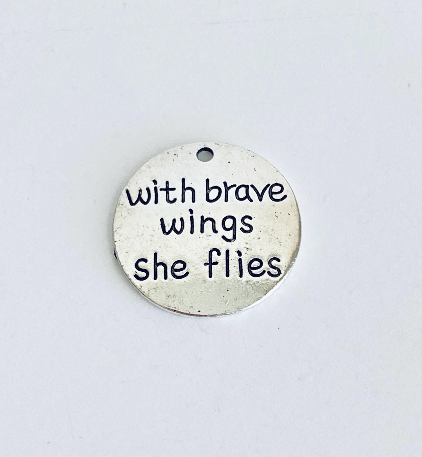 With brave wings she flies Charm