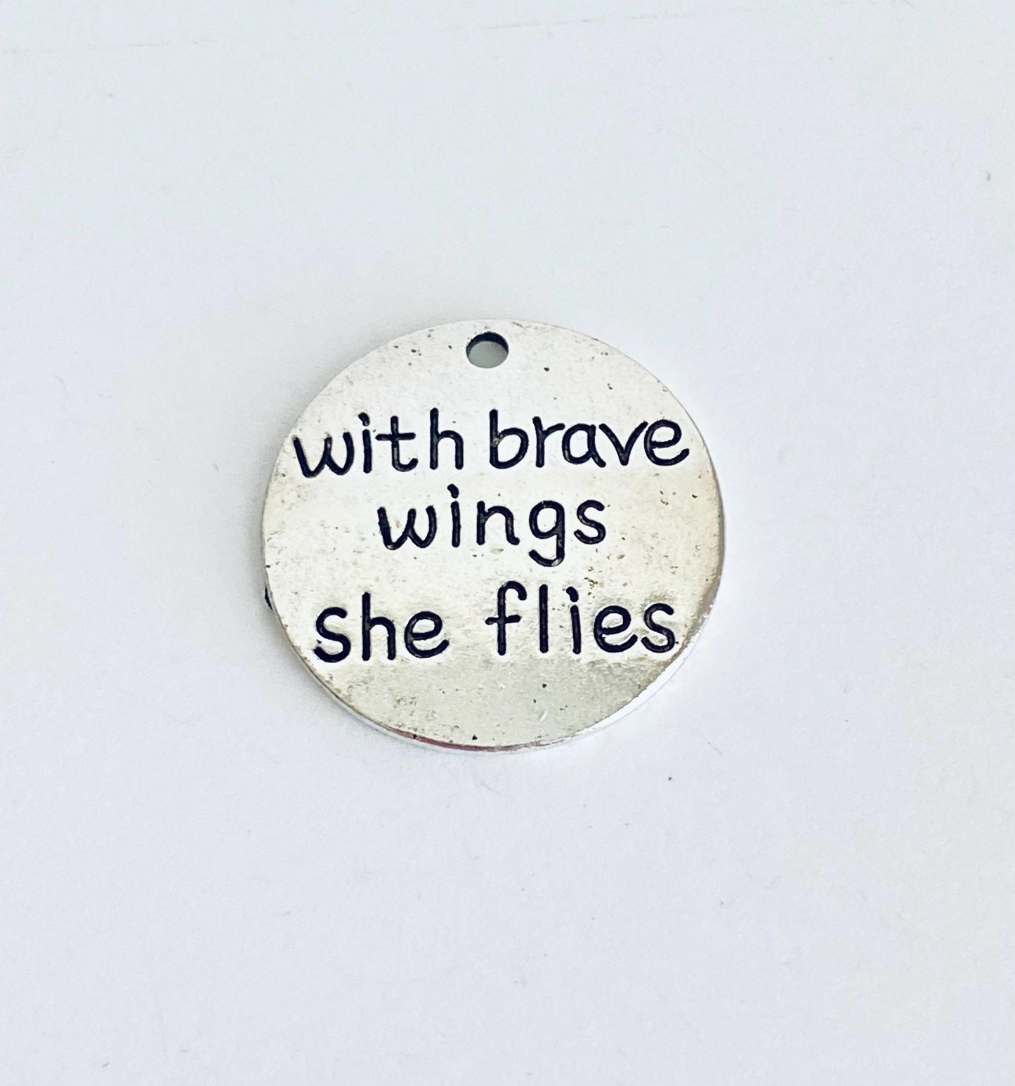 With brave wings she flies Charm