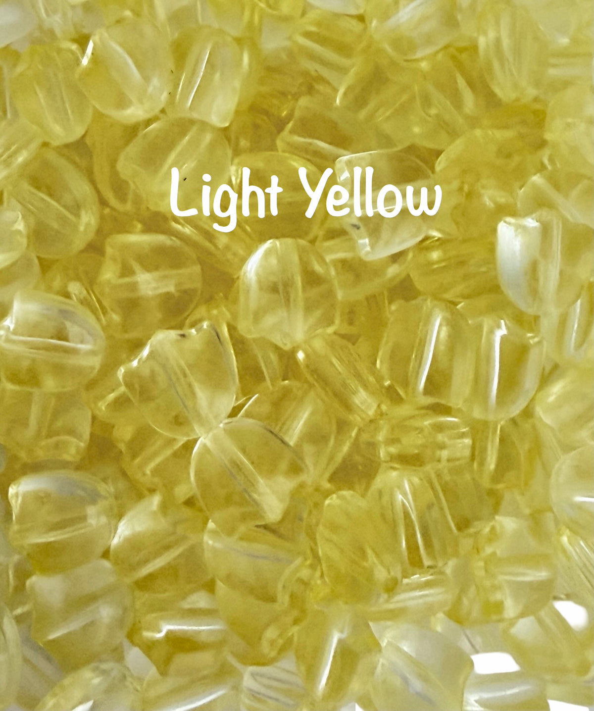 A close-up of many small translucent light yellow beads or chips filling the frame, with the words 'Light Yellow' overlaid in white text.